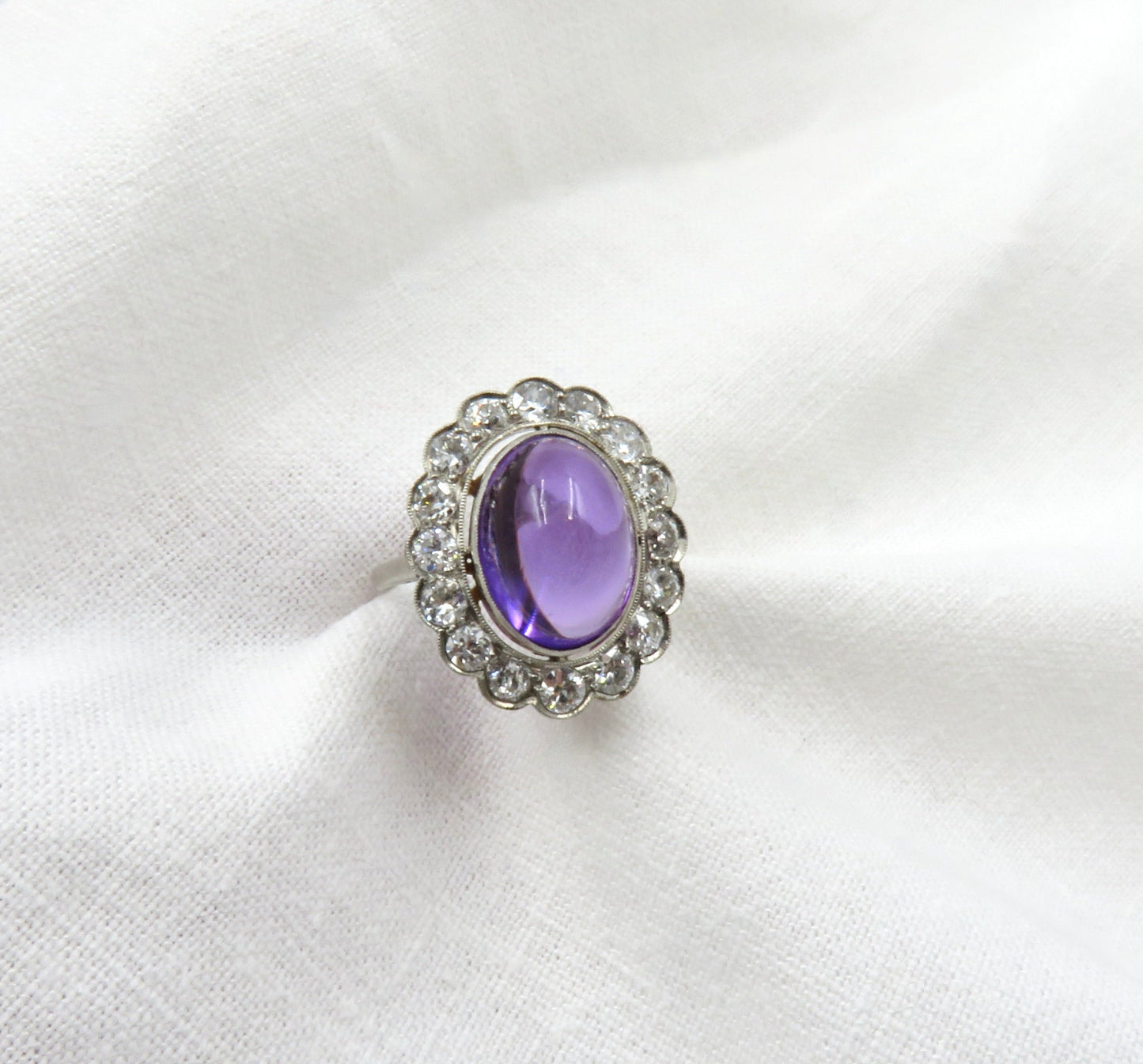 Circa 1920 Platinum Ring Set with Cabochon Amethyst and Old European Cut Diamonds