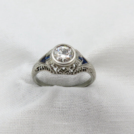 Art Deco Diamond and Platinum Engagement Ring centered with a 0.75 ct Early Modern Round Brilliant Cut Diamond. F Color