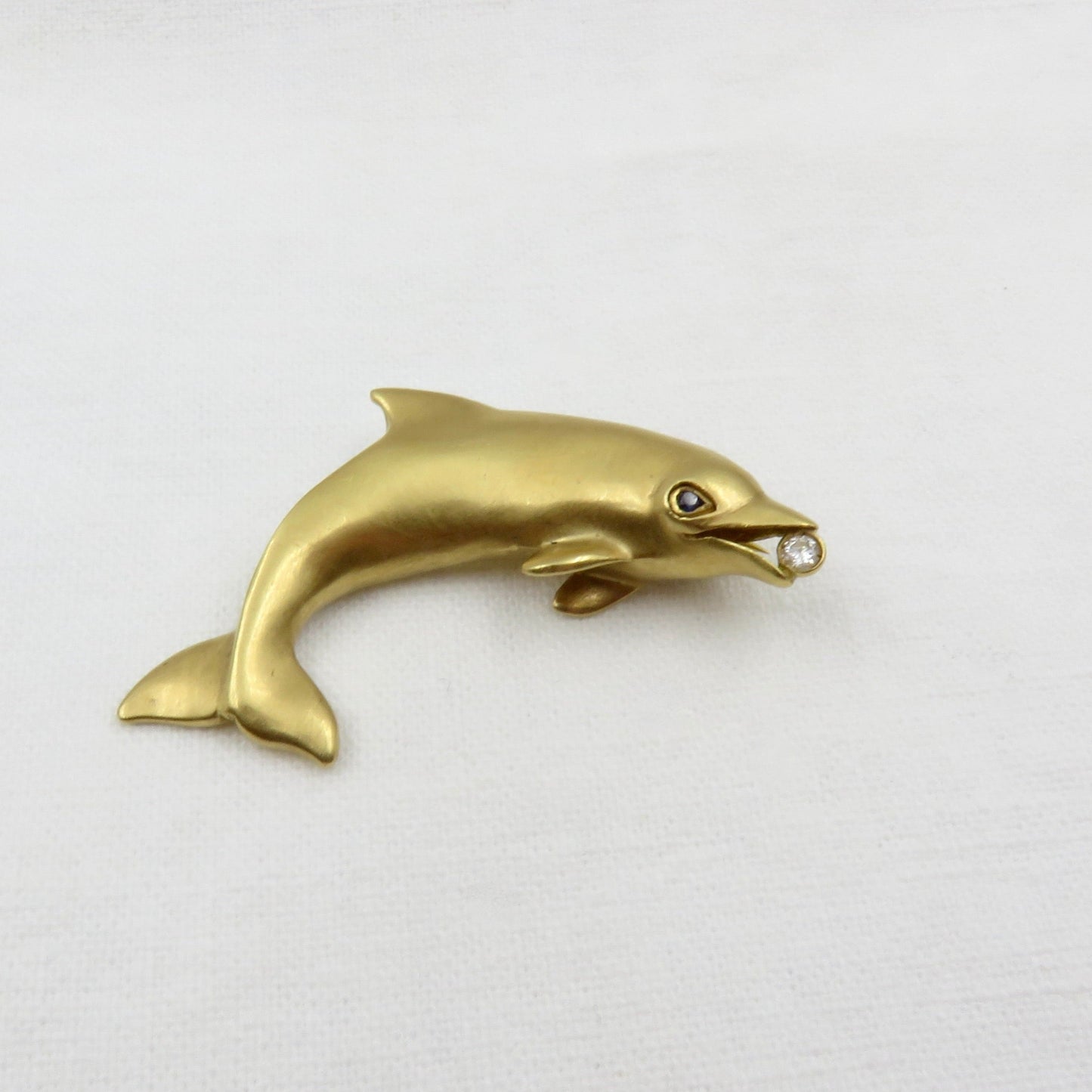 Circa 1970 Tiffany 18karat Gold Diamond and Sapphire Dolphin Pin