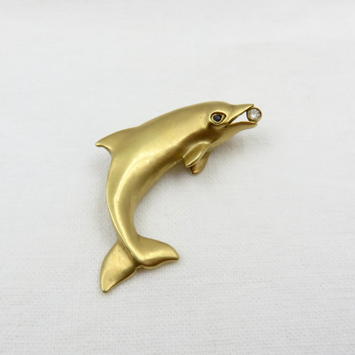 Circa 1970 Tiffany 18karat Gold Diamond and Sapphire Dolphin Pin